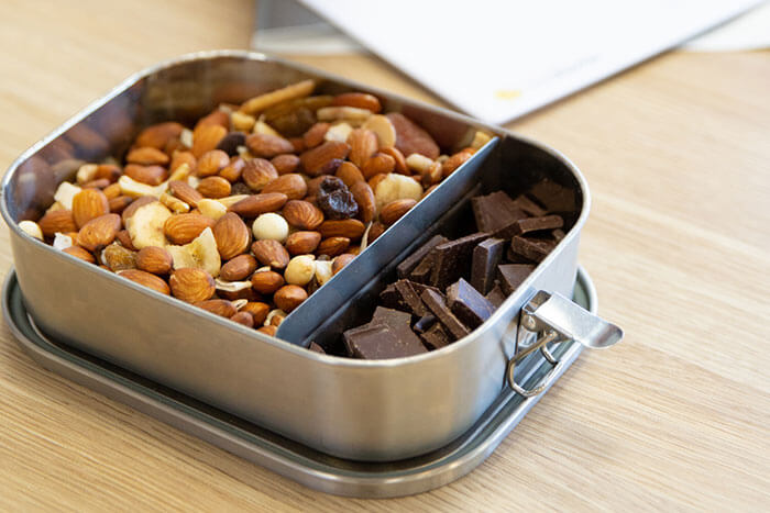 grey lunchbox with nuts and chocolate