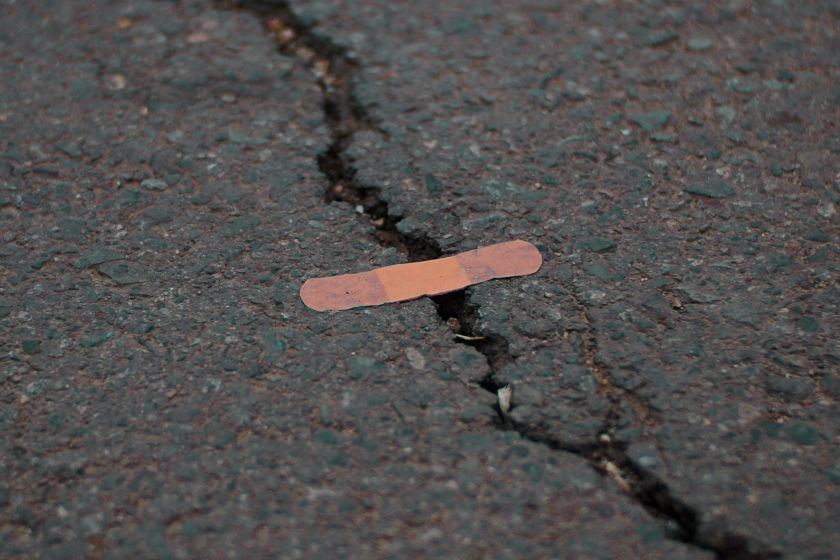 Band-aid on a crack in the road symbolising some organisation mental health initiatives