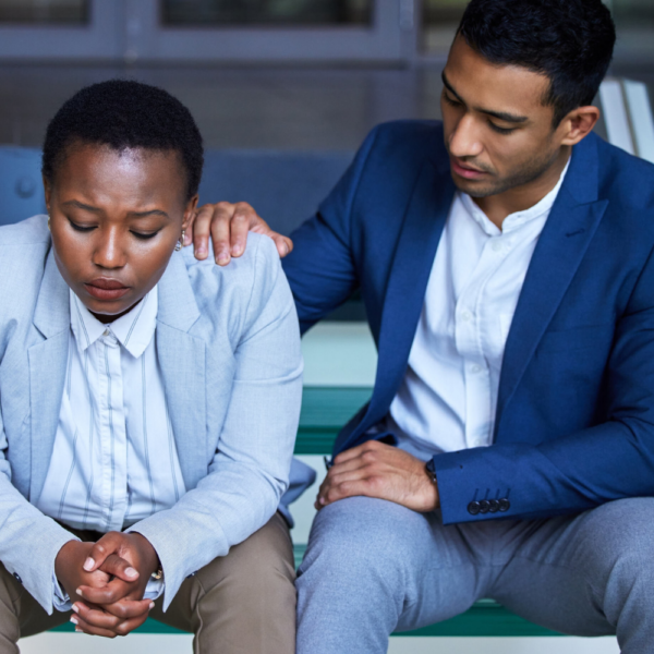 man comforting woman